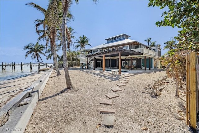 exterior space featuring a water view and a pergola