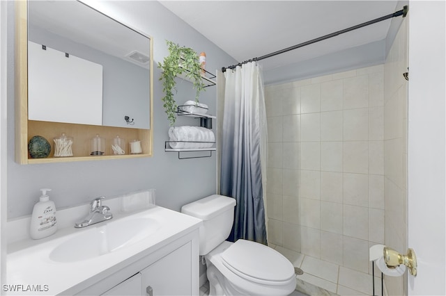 bathroom featuring vanity, a shower with shower curtain, and toilet