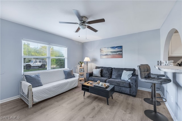 living room with light hardwood / wood-style floors and ceiling fan