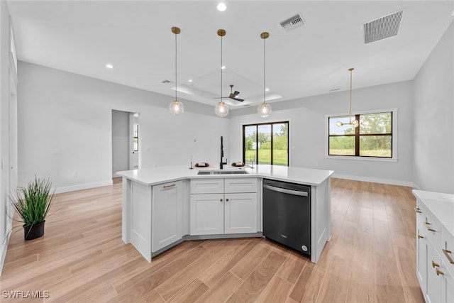 kitchen featuring dishwasher, a kitchen island with sink, sink, light wood-type flooring, and white cabinetry