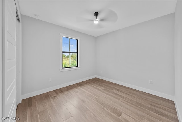 spare room featuring light hardwood / wood-style flooring and ceiling fan