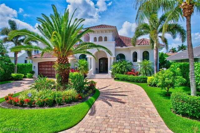 mediterranean / spanish home featuring a garage