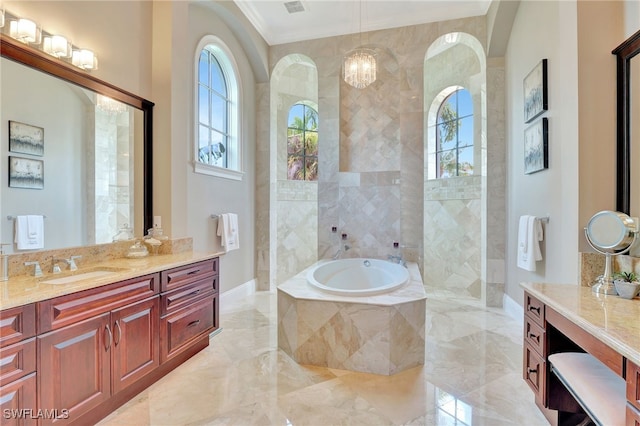 bathroom featuring a wealth of natural light, crown molding, tiled tub, and vanity