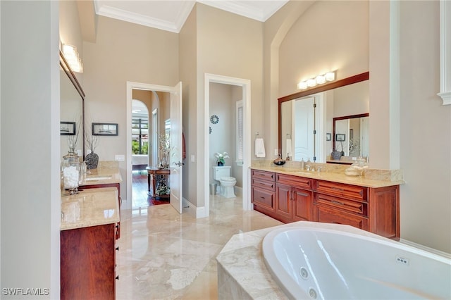 bathroom with a relaxing tiled tub, toilet, vanity, and ornamental molding