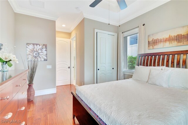 bedroom featuring ceiling fan, a closet, ornamental molding, and light hardwood / wood-style floors