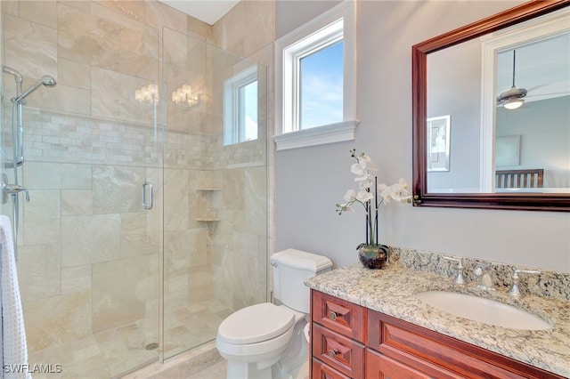 bathroom featuring walk in shower, vanity, ceiling fan, and toilet