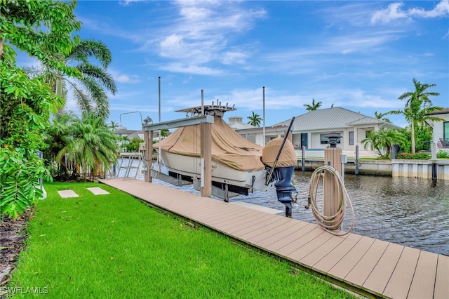 dock area with a yard and a water view