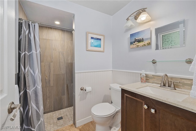 bathroom featuring vanity, toilet, curtained shower, and hardwood / wood-style floors