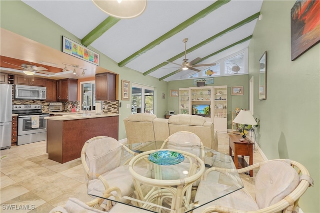 tiled dining room with ceiling fan, high vaulted ceiling, beamed ceiling, and a fireplace