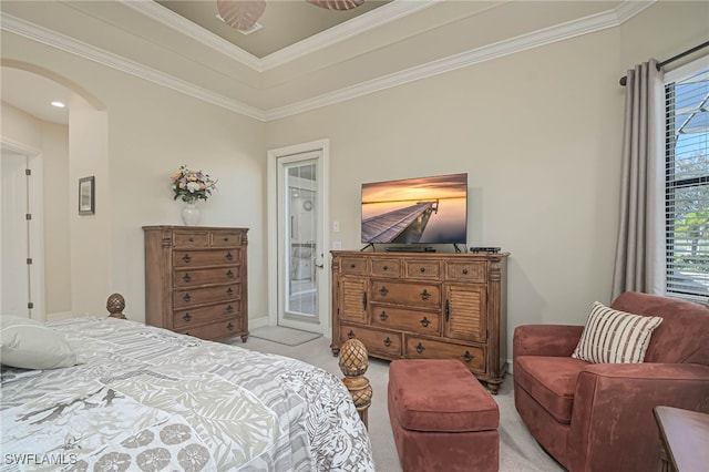 bedroom with ornamental molding and light colored carpet