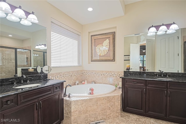 bathroom featuring vanity, shower with separate bathtub, and tile patterned floors