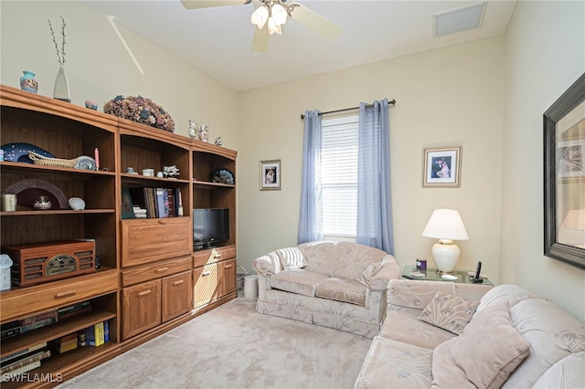 carpeted living room with ceiling fan