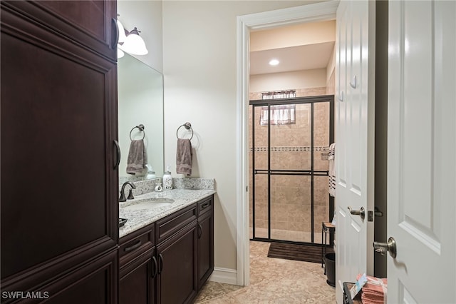 bathroom featuring vanity, tile patterned floors, and walk in shower