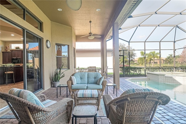 sunroom / solarium featuring ceiling fan and a pool