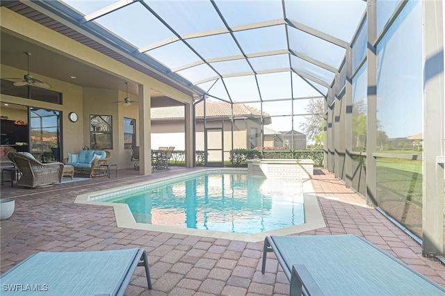 view of pool featuring ceiling fan, glass enclosure, a patio area, and outdoor lounge area