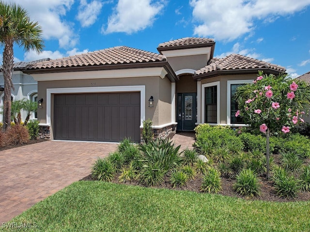 mediterranean / spanish-style home with a garage