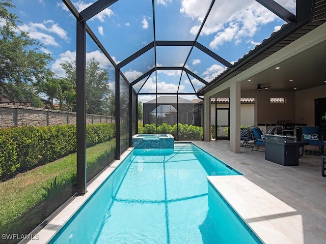 view of pool with a patio area, ceiling fan, an in ground hot tub, and glass enclosure