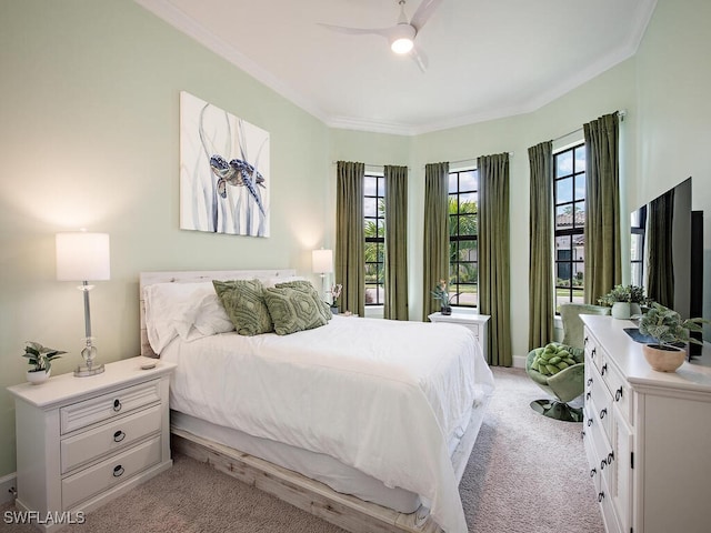 carpeted bedroom with ornamental molding and ceiling fan