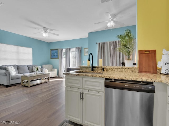 kitchen with sink, light stone counters, light hardwood / wood-style flooring, white cabinets, and dishwasher