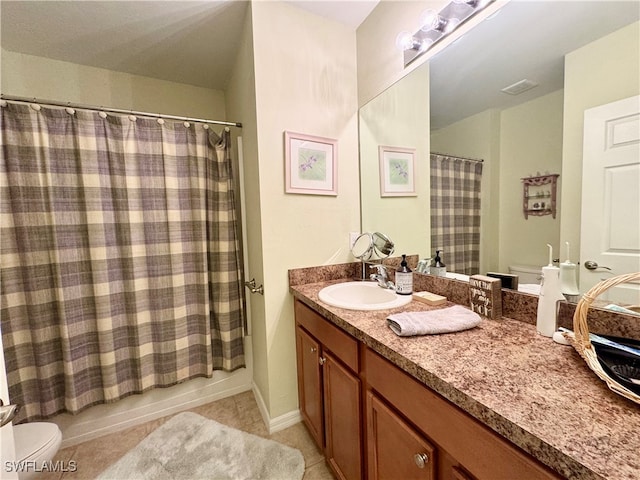 full bathroom featuring vanity, toilet, shower / bath combo with shower curtain, and tile patterned flooring