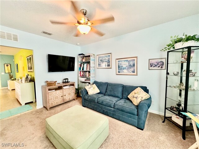 carpeted living room with ceiling fan