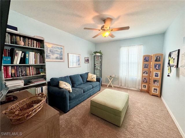 living room with ceiling fan, carpet, and a textured ceiling