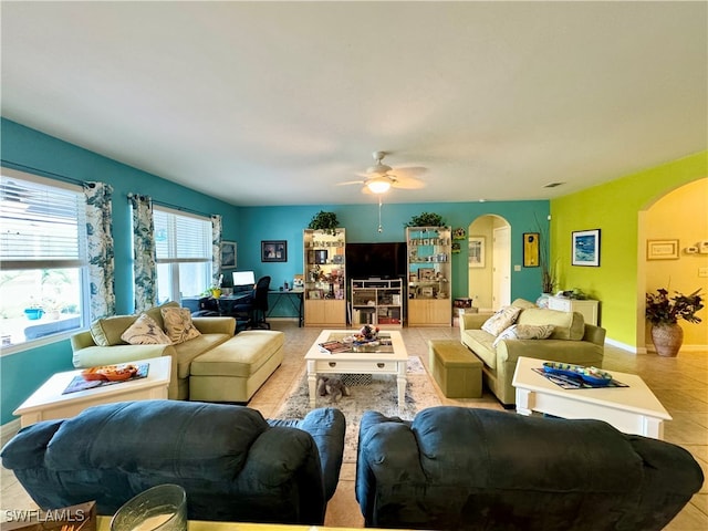 tiled living room with ceiling fan