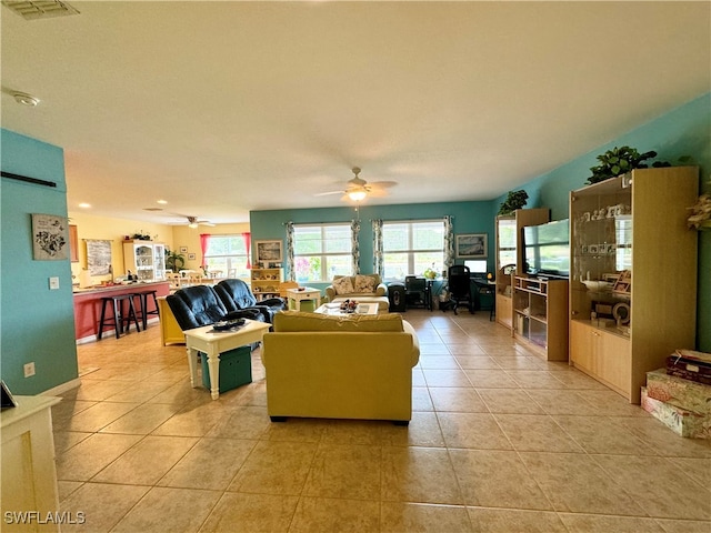 tiled living room with ceiling fan