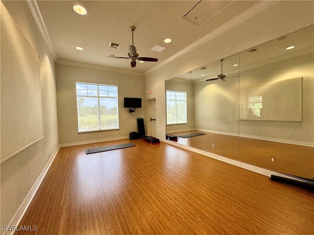 workout area featuring ornamental molding, hardwood / wood-style flooring, and ceiling fan