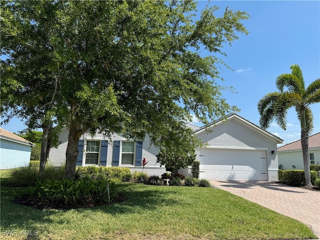 view of front of property with a garage and a front lawn