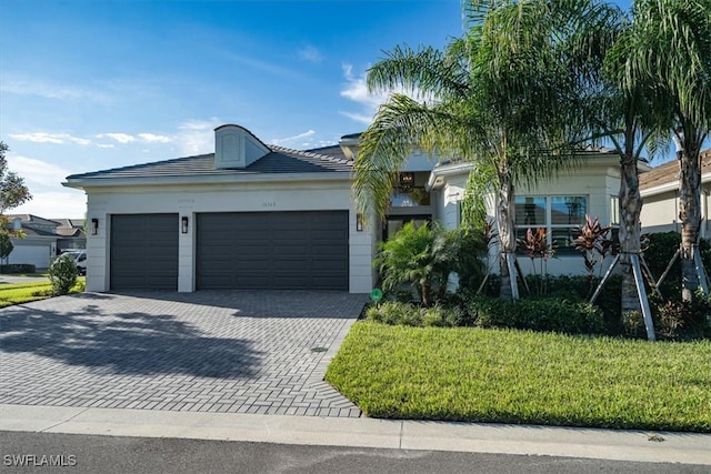 view of front of house with a front yard and a garage