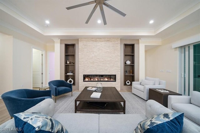 living room with ornamental molding, ceiling fan, and built in features