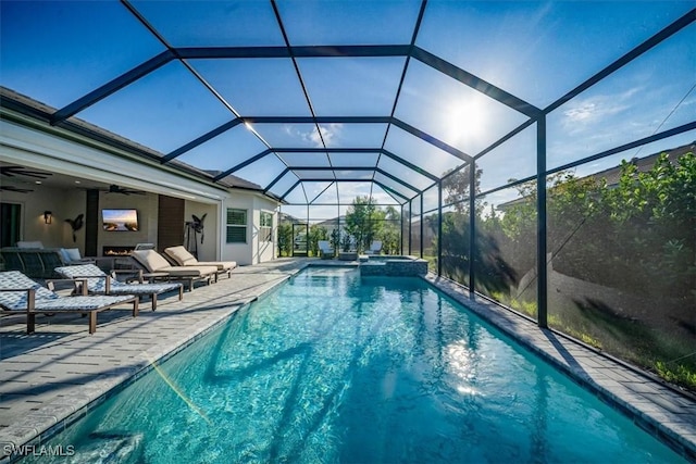 view of swimming pool with a patio, a lanai, a ceiling fan, and a pool with connected hot tub