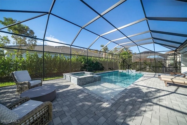 view of swimming pool with a patio area, glass enclosure, and a pool with connected hot tub