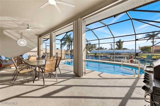 view of swimming pool featuring a patio area, ceiling fan, and a lanai