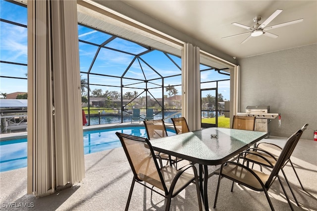 interior space featuring a lanai, ceiling fan, and a water view