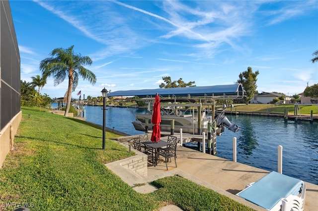 dock area with a water view and a lawn