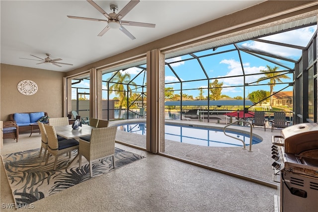 sunroom / solarium with ceiling fan and a pool