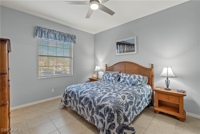 tiled bedroom featuring ceiling fan