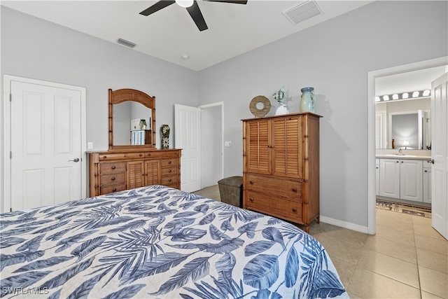 bedroom featuring ensuite bathroom, ceiling fan, light tile patterned floors, and sink