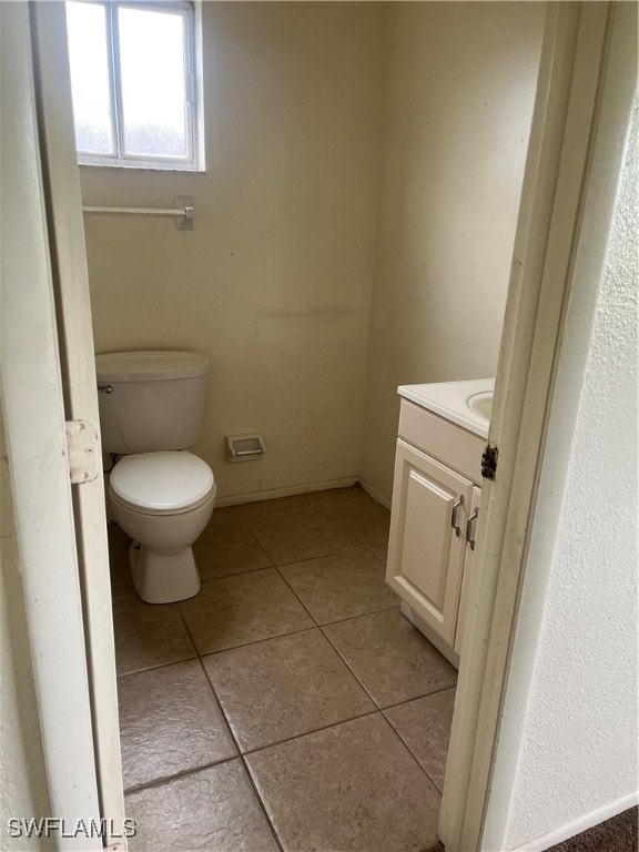 bathroom featuring vanity, toilet, and tile patterned floors