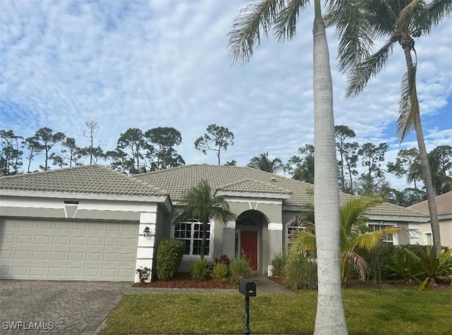 view of front of property featuring a garage and a front lawn