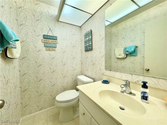 bathroom with vanity, toilet, and tile patterned floors