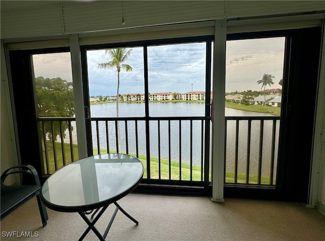 sunroom / solarium featuring a water view