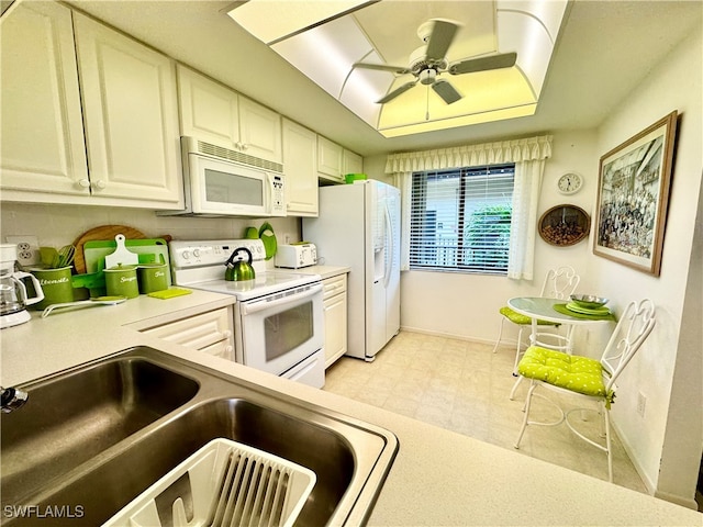 kitchen with sink, white appliances, and ceiling fan