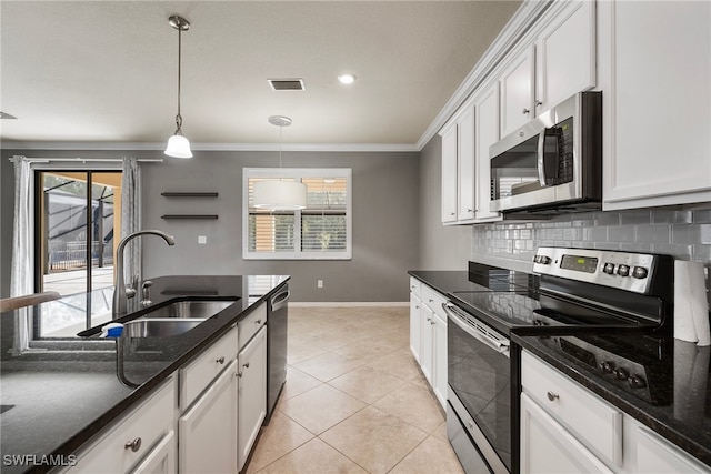 kitchen featuring white cabinets, a wealth of natural light, sink, pendant lighting, and stainless steel appliances