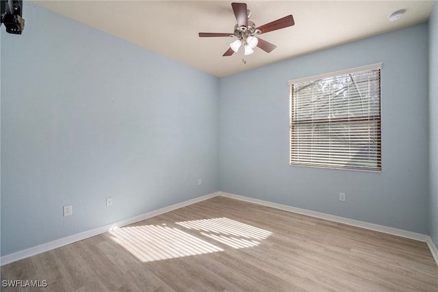 unfurnished room with ceiling fan and light wood-type flooring