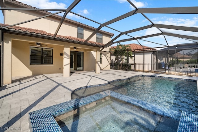 view of swimming pool with a patio, ceiling fan, and a lanai