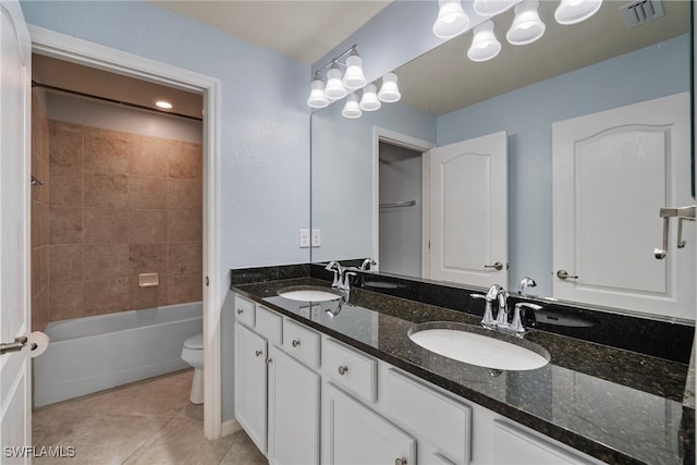 full bathroom featuring vanity, toilet, tile patterned flooring, and tiled shower / bath