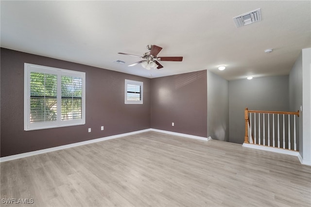 empty room with light hardwood / wood-style flooring and ceiling fan